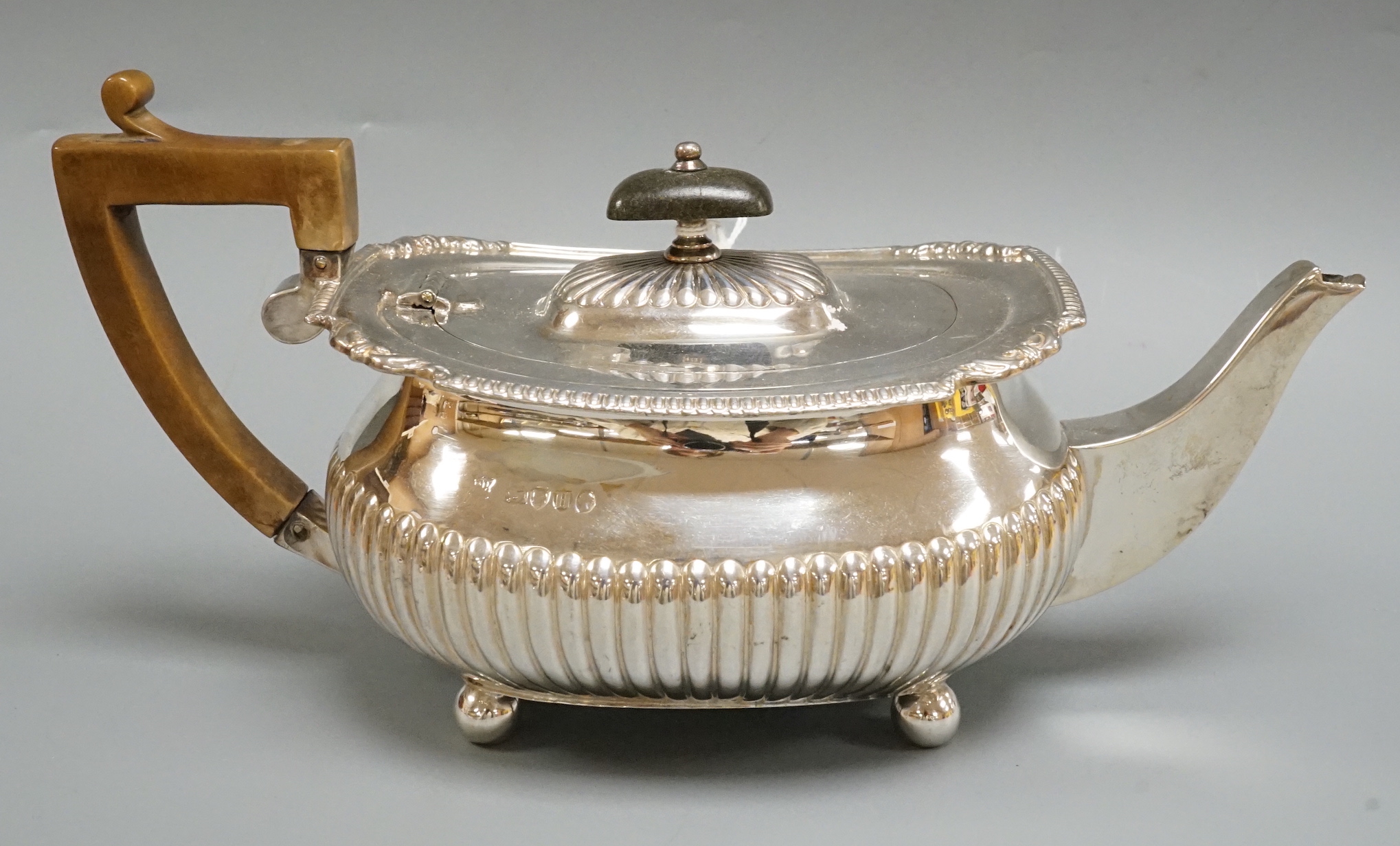A Victorian demi-fluted silver teapot, Edward Hutton, London, 1883, gross weight 16oz.